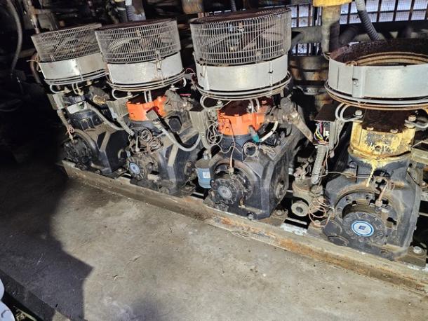 Commercial refrigeration compressor rack, low temp 404A, 50 HP, used condition, metal components, industrial setting.
