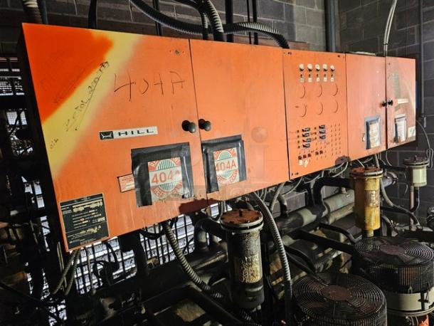Commercial refrigeration compressor rack, orange, low temp 404A, 50 HP, Hill brand. Markings and labels visible.
