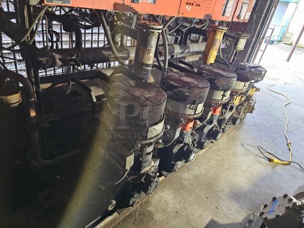 Commercial refrigeration compressor rack, low temp 404A, 50 HP. Visible cables and compressor units, industrial setting.