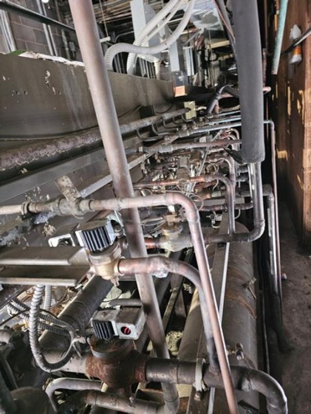 Commercial refrigeration compressor rack, low temp, 404A, 50 HP. Pipes and components visible, used condition. Safe removal required.