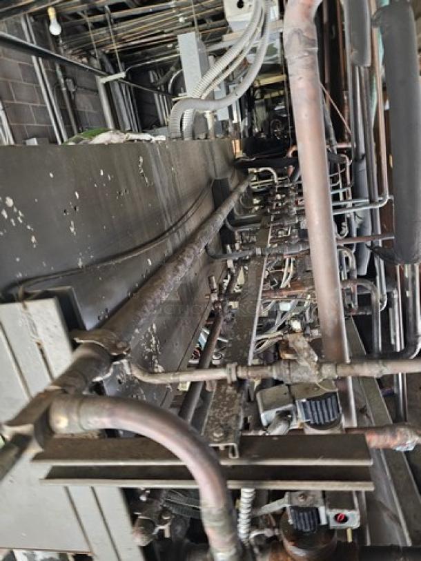 Commercial refrigeration compressor rack, 50 HP, low temp, 404A refrigerant. Visible wear. Buyer responsible for removal.