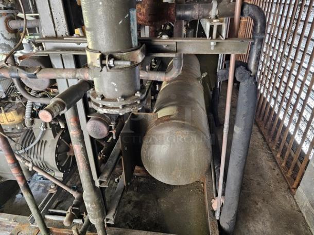 Commercial refrigeration compressor rack, low temp, 404A, 50 HP. Metal pipes and tanks in used condition. Buyer removal required.