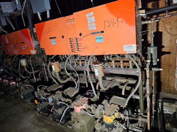 Commercial refrigeration compressor rack, medium temp, 134A, 40 HP. Orange panels, visible labels and wiring, used condition.