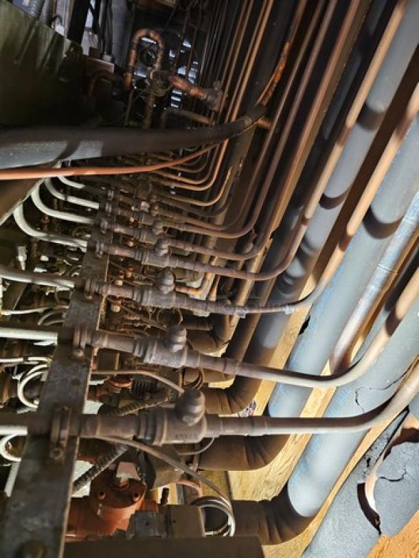 Commercial refrigeration compressor rack, medium temp, 134A, 40 HP. Complex piping visible, requires safe removal.