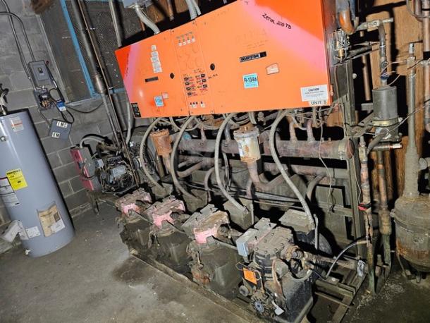 Commercial refrigeration compressor rack, medium temp, R134A, 40 HP, used condition, visible wear and labels.