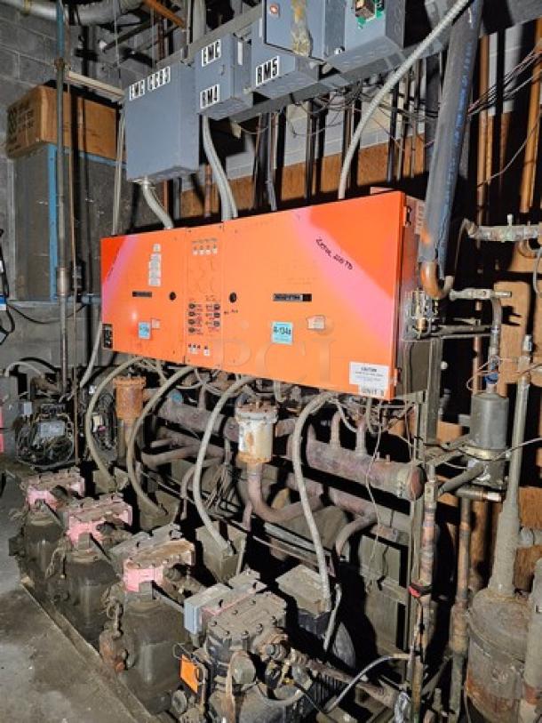 Commercial refrigeration compressor rack, medium temp, 134A, 40 HP, includes visible control panels and piping.