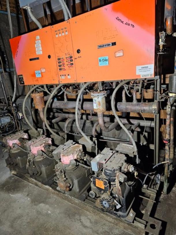Commercial refrigeration compressor rack, 40 HP, medium temp, 134A, with visible control panels and piping, used condition.