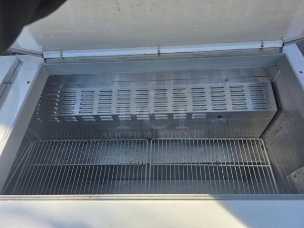 Continental SW72-30M 72″ commercial sandwich prep unit, stainless steel, open top view showing interior racks and vents.