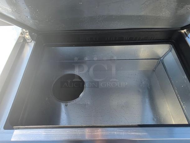 True 2 Door Pizza Prep Table TPP-67 interior, stainless steel, model TPP-67, clean and well-maintained.