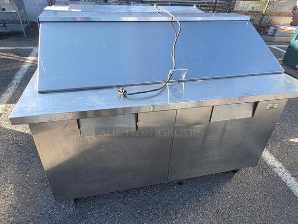 True QA-60-24M-B 60" refrigerated prep table, stainless steel, dual compartments, visible wear, electrical cord attached.