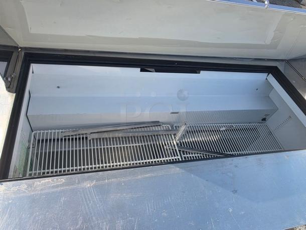 True QA-60-24M-B 60" refrigerated prep table, open lid view, white interior, wire shelving, clean condition.