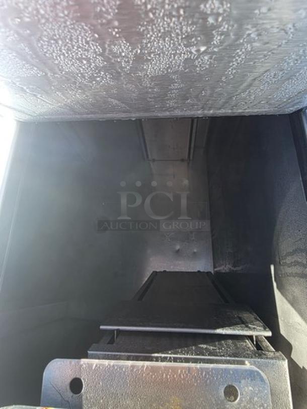 Delfield model KCF-50 ice cream counter interior, showing spacious stainless steel compartment with minor wear.