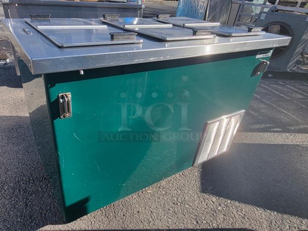 Delfield KCF-50 ice cream counter with stainless steel lids, green exterior, and visible ventilation panel. Good condition.