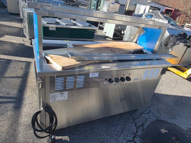 Delfield SH-4-NU 60" Shelleysteel electric hot food serving counter, stainless steel, knobs and power cord visible, fair condition.