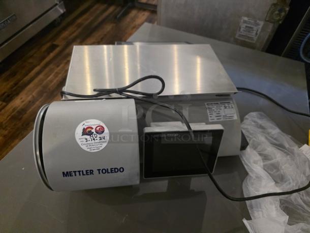 Mettler Toledo UCCW Smart Touch counter scale for deli or bakery use, featuring a digital display and stainless steel platform.
