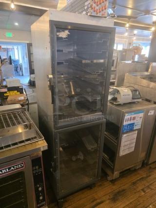 Metro DD8119 Transport Cabinet, stainless steel, multiple trays, dual glass doors, used condition, ideal for food service.