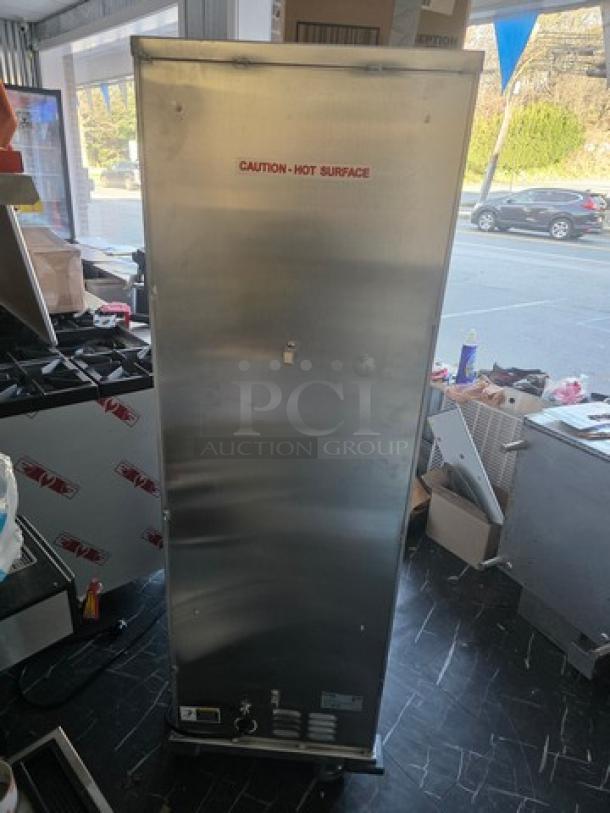 Koolmore KM-CH36-SNGL commercial heated holding/proofing cabinet in stainless steel. "Caution: Hot Surface" warning visible.