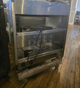 International Dairy Queen DD29 Double Level Food Warmer, stainless steel, used condition, visible cords, on wheels.