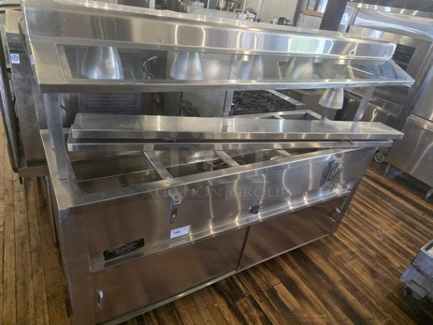 Custom 5 well steam table, stainless steel, with overhead lighting, in good condition. Features enclosed base and fitted sneeze guard.