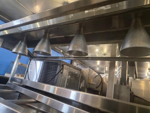 Custom 5 well steam table with stainless steel construction, overhead heat lamps, and multiple compartments. Good condition.