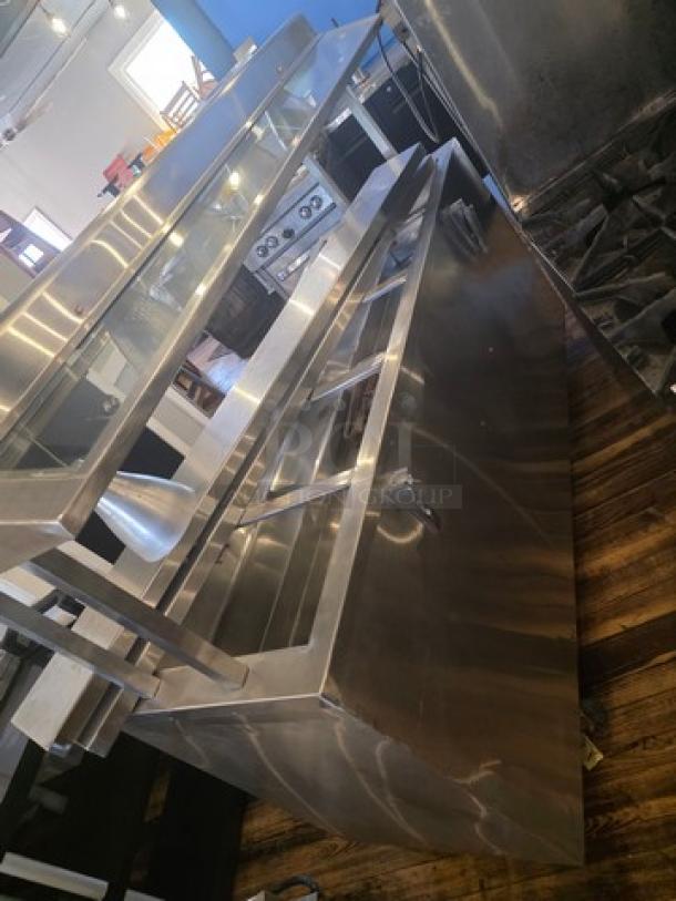 Custom 5 well steam table in stainless steel, excellent condition. Includes control panel, glass top shelf, and tubular legs.