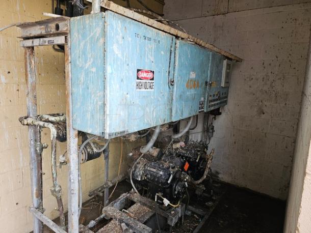 Commercial refrigeration compressor rack, medium temp, 40 HP, 404A, weathered condition. "Danger High Voltage" label visible.