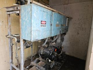 Commercial refrigeration compressor rack, medium temp, 40 HP, 404A, weathered condition. "Danger High Voltage" label visible.