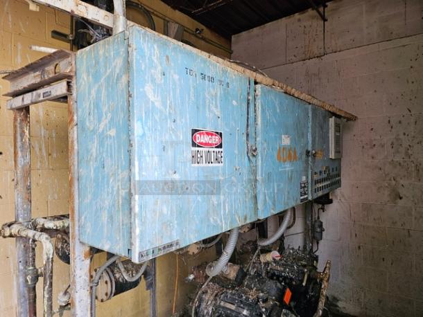 Commercial refrigeration compressor rack, 40 HP, medium temp, 404A. Blue casing with "High Voltage" warning label. Worn condition.