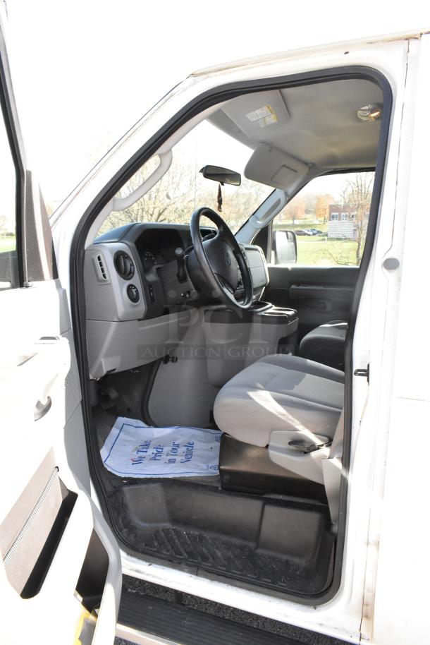 2012 Ford E-350 Van interior, driver's side view. Features removable back seats, odometer at 96,764 miles, VIN 1FBSS3BL3CDA01043.