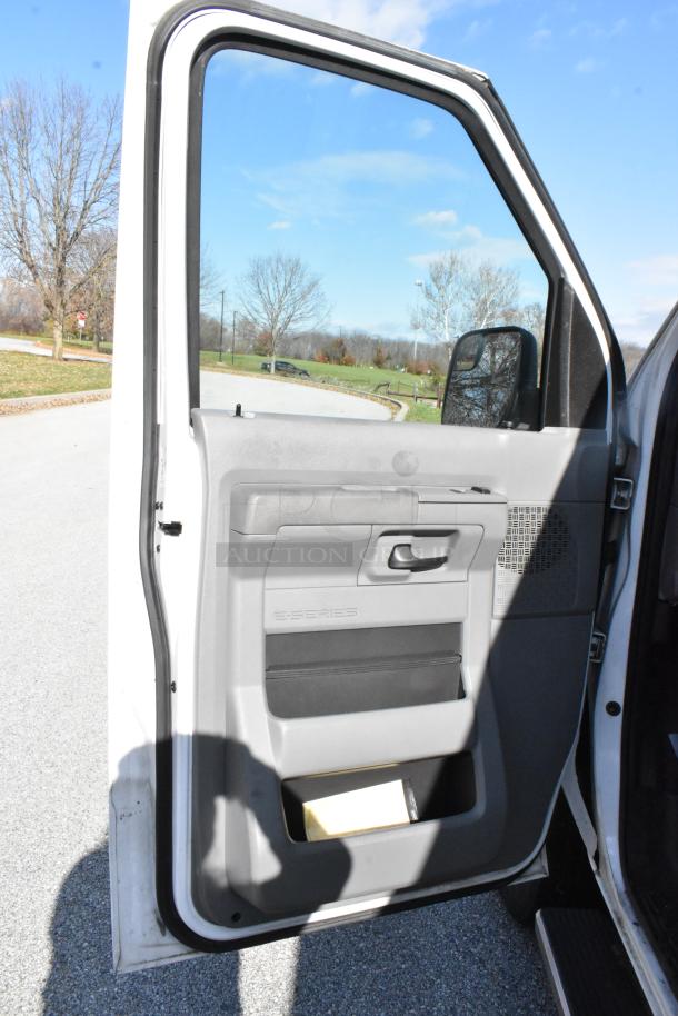 2012 Ford E-350 Van, door open, showcasing interior door panel. Comes with 4 removable back seats. Odometer: 96,764 miles. VIN 1FBSS3BL3CDA01043.