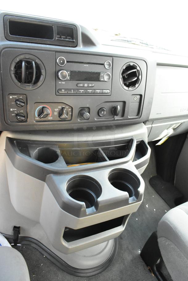 2012 Ford E-350 Van interior showing dashboard controls and cup holders. Odometer: 96,764 miles. VIN: 1FBSS3BL3CDA01043.