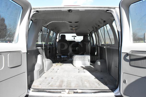 2012 Ford E-350 Van, interior view, shows empty cargo area with removable seats, odometer 96,764 miles. VIN 1FBSS3BL3CDA01043.