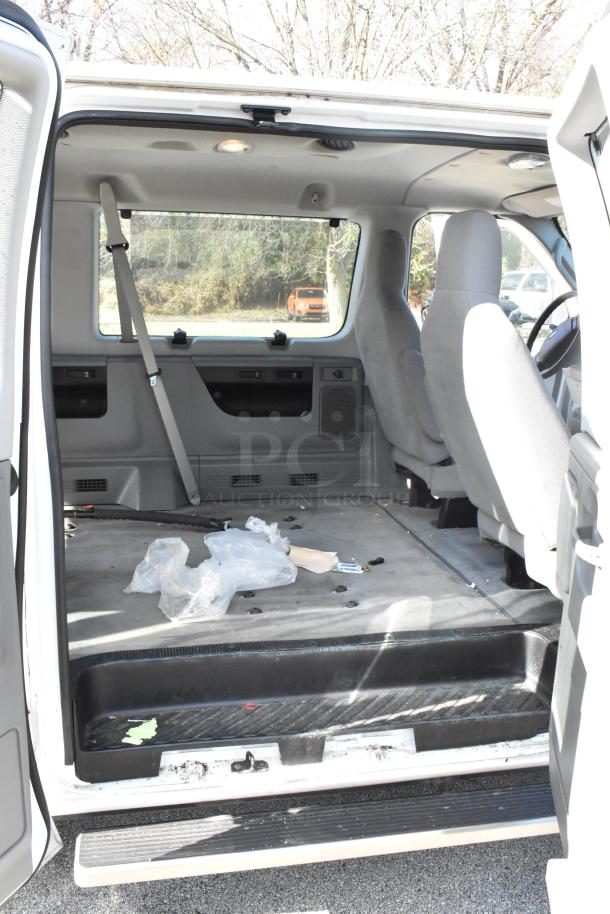2012 Ford E-350 Van interior view, 4 removable back seats, odometer reads 96,764 miles, VIN 1FBSS3BL3CDA01043.