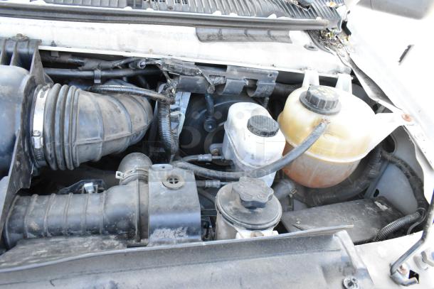 2012 Ford E-350 Van engine bay showing components and condition. Odometer at 96,764 miles, VIN 1FBSS3BL3CDA01043.