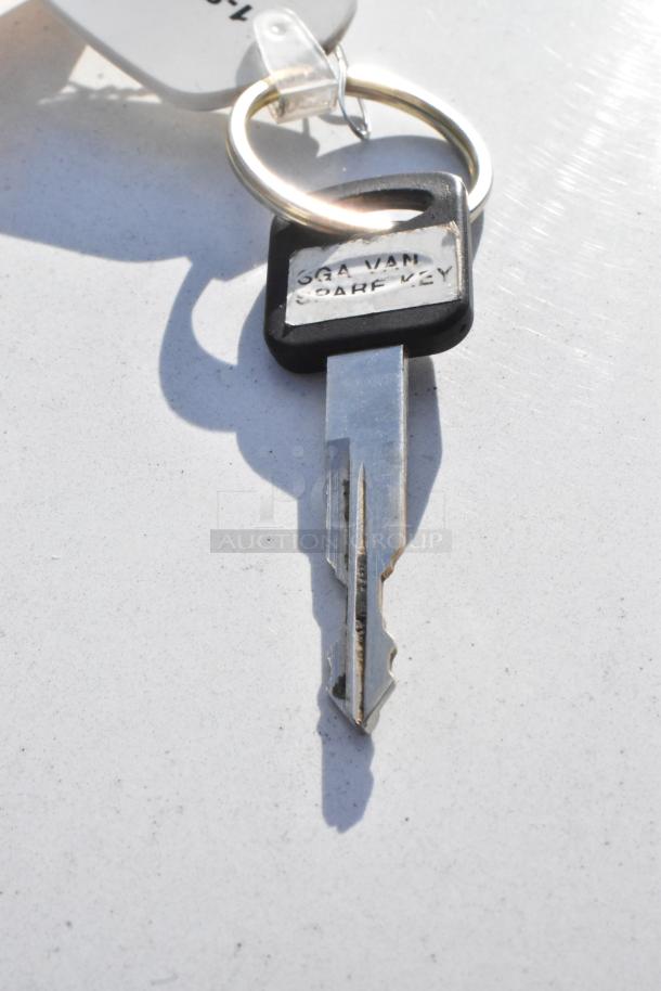 Key for 2012 Ford E-350 Van with “SGA VAN SPARE KEY” label. Key ring included.