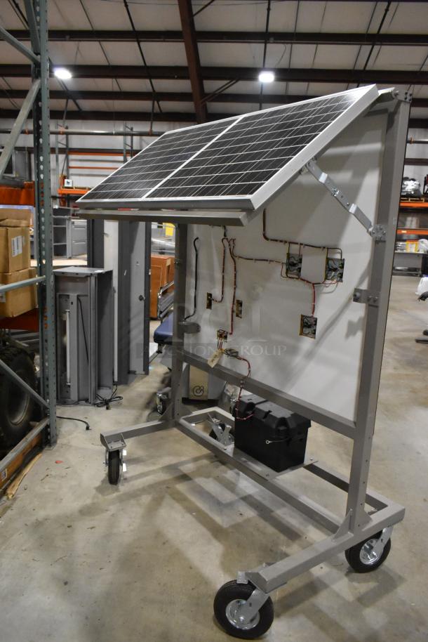 Kyocera solar panels mounted on Hampden controller frame with wheels, wiring visible; industrial setting.