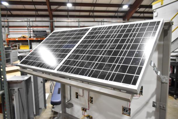 Kyocera solar panels mounted on Hampden controller, in good condition. Features metal frame and visible wiring connections.