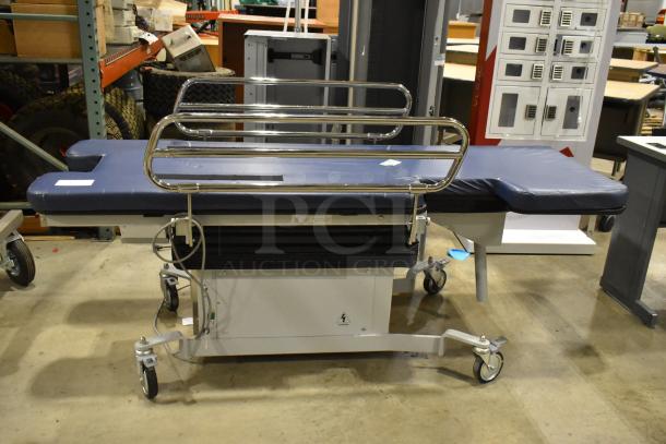 Northeast Medical Systems portable hospital bed on commercial casters, 120 volts, 1 phase, blue padding, metal rails, good condition.