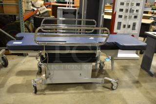 Northeast Medical Systems portable hospital bed on commercial casters, 120 volts, 1 phase, blue padding, metal rails, good condition.