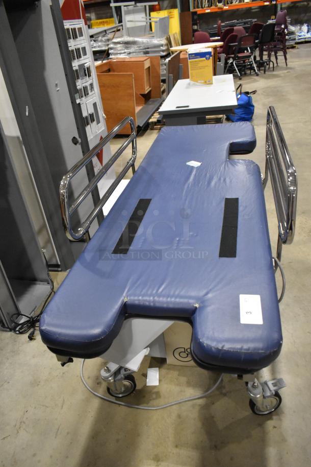Northeast Medical Systems portable hospital bed, blue cushioning, chrome side rails, commercial casters, 120V, 1 phase.