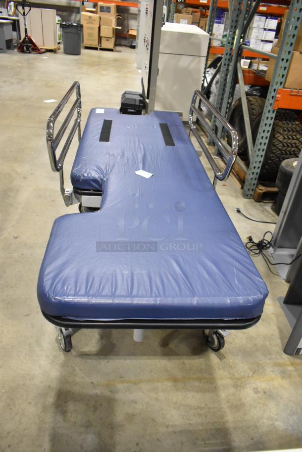 Northeast Medical Systems portable hospital bed with blue padding, chrome side rails, commercial casters, 120V, 1 phase.