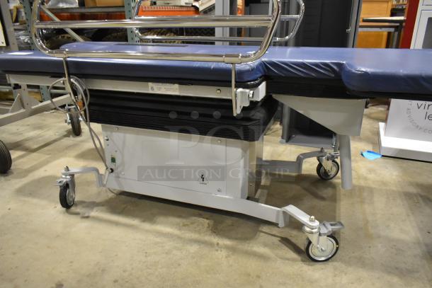 Northeast Medical Systems portable hospital bed with commercial casters, 120 volts, 1 phase, blue mattress, metal rails.