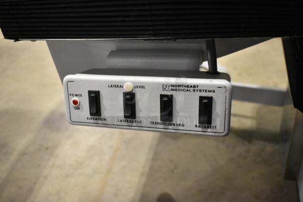 Northeast Medical Systems control panel for a portable hospital bed, featuring elevation, lateral tilt, Trendelenburg, and backrest controls.