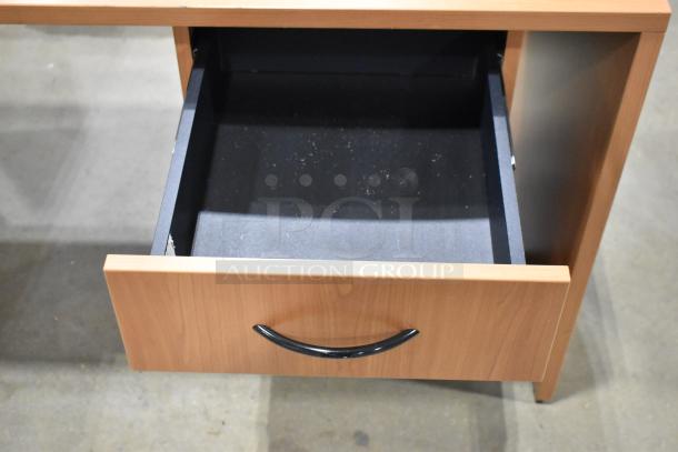 Wood pattern desk with open 3-drawer filing cabinet. Black handle, good condition. Ideal for office organization.