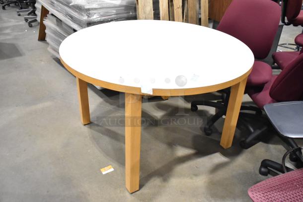 Round white table with wood pattern rim and legs, in good condition. Ideal for dining or conference use.