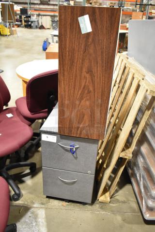 Gray 2-drawer filing cabinet with label "QTY V X 2" and wooden 24-cubby mailer. Auction includes both, good condition.