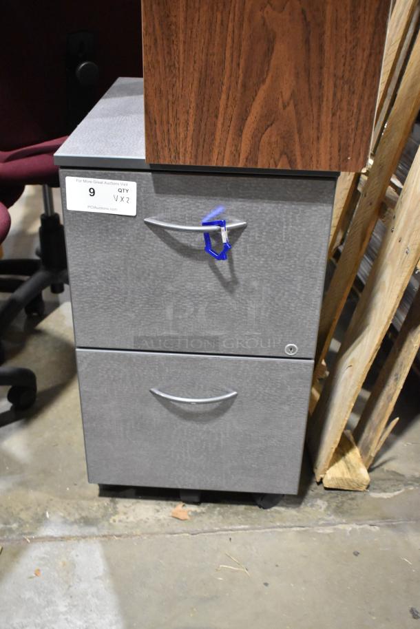 Gray 2-drawer filing cabinet with silver handles, lockable, and a wooden 24-cubby mailer on top, both in good condition.