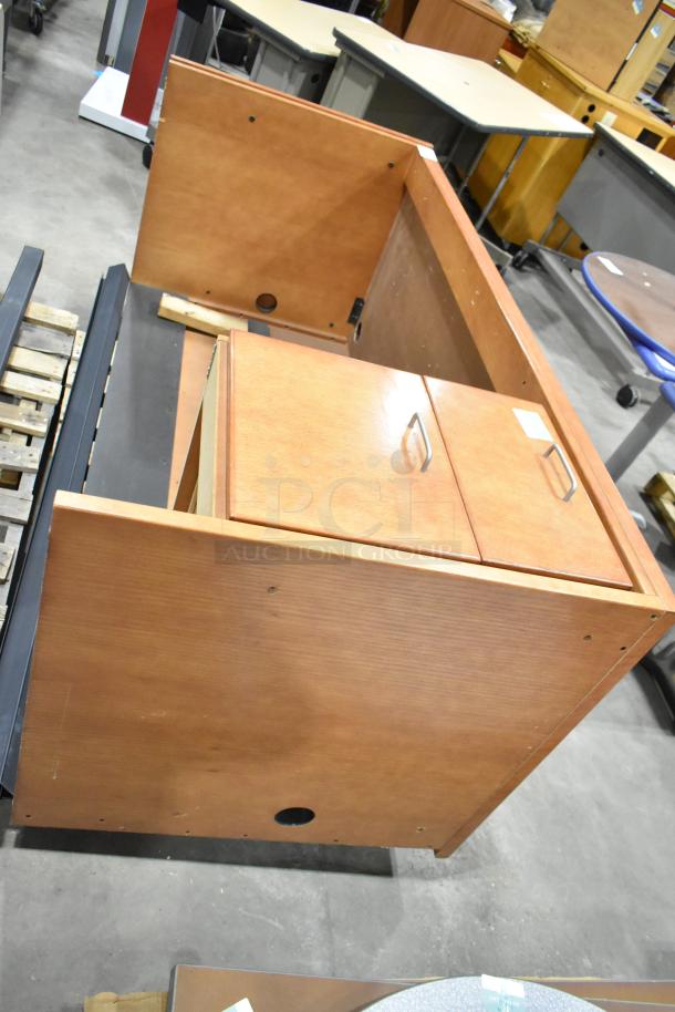 Wood pattern desk with two-drawer filing cabinet, brown wooden finish, includes metal handles, in good condition.