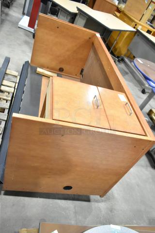 Wood pattern desk with two-drawer filing cabinet, brown wooden finish, includes metal handles, in good condition.