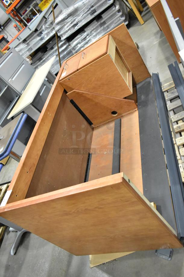 Wood pattern desk with 2-drawer filing cabinet. Features a sturdy frame, wood grain finish. Needs assembly; missing parts visible.